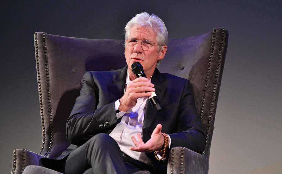 Richard Gere speaks at the microphone.