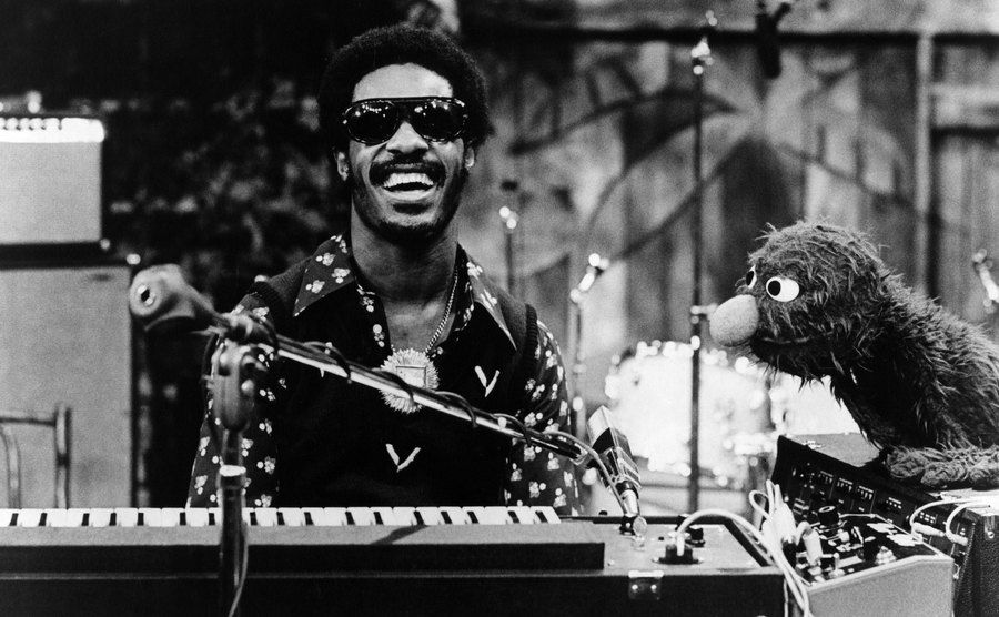 Stevie Wonder appears on Sesame Street with Grover.