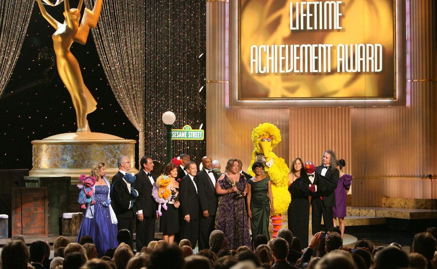 The cast and crew of “Sesame Street” are onstage at the Emmy Awards.