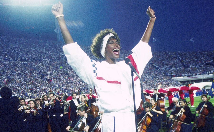 A photo of Whitney Houston performing at the Super Bowl XXV.