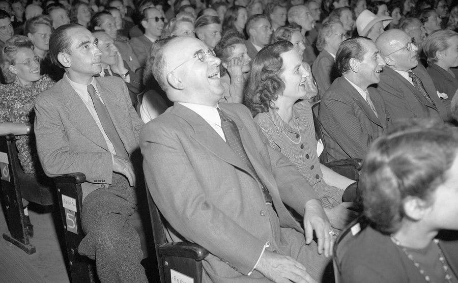 An image of an audience laughing.