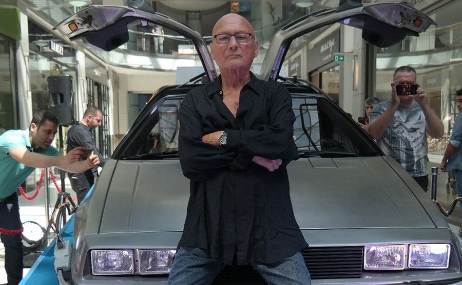 James Tolkan poses in front of the DeLorean featured in the movie 'Back to the Future.'