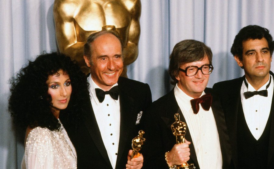 Placido Domingo and Cher pose with Henry Mancini and Leslie Bricusse after winning an award.