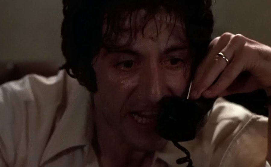 A movie still of Al Pacino looking sweaty.