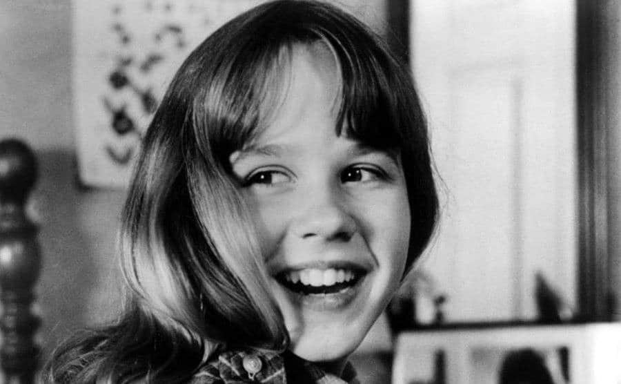 A portrait of Linda Blair smiling on the filming set.