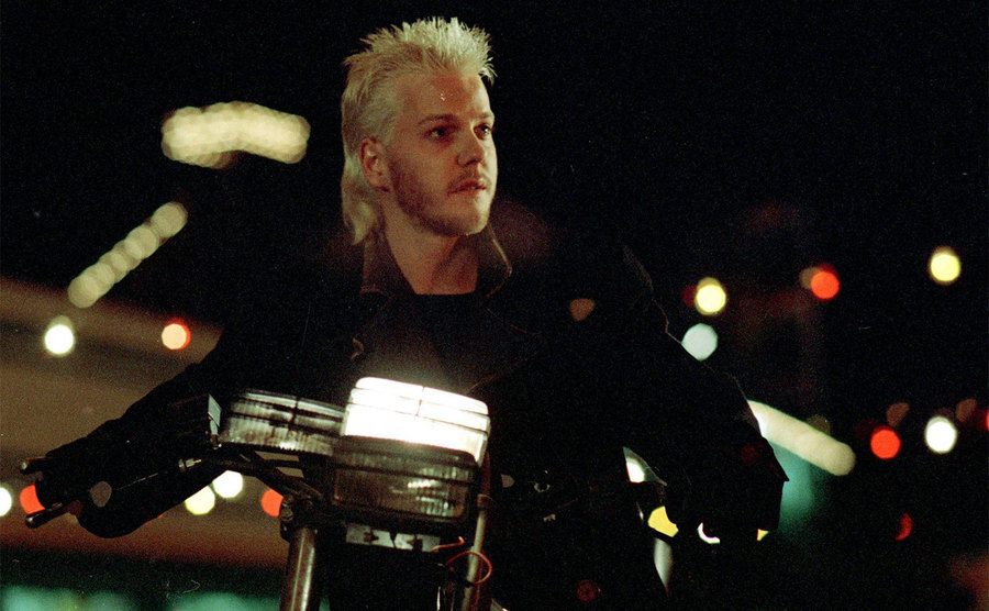 Sutherland rides a motorcycle in a still from The Lost Boys.