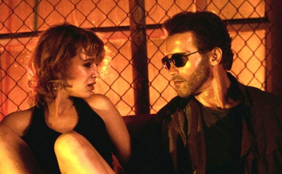 A still of Penelope Ann Miller and Schwarzenegger in a scene from the film.