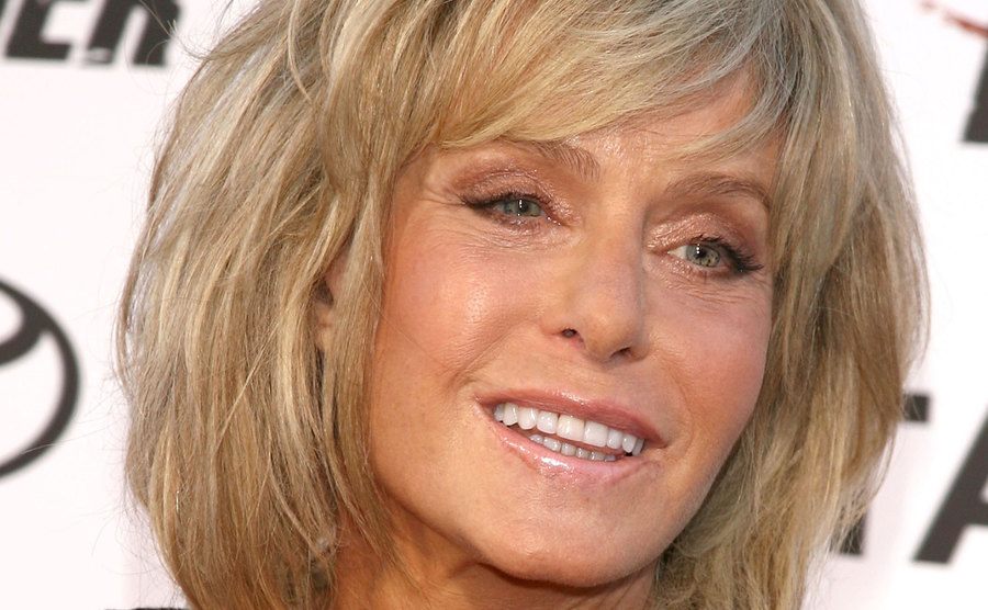 A picture of Farrah Fawcett posing for the press. 