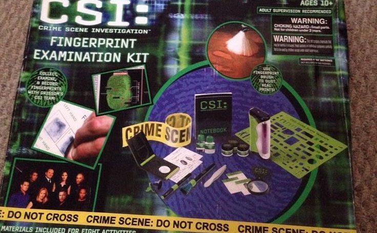 CSI Fingerprint Examination Kit is on the carpeted floor. 