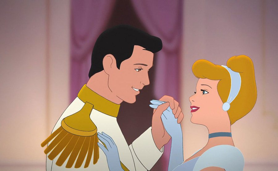 Prince Charming and Cinderella share a dance. 