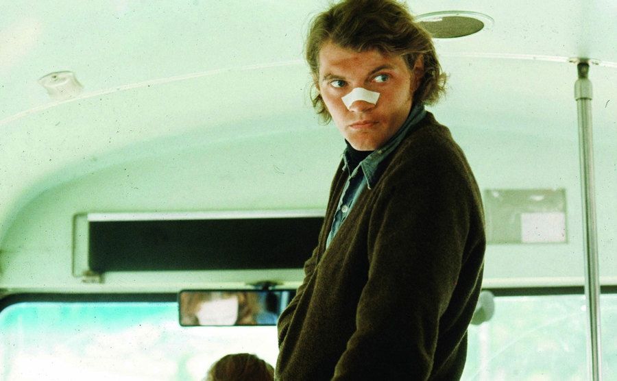 A still of Andrew in a scene inside a bus.