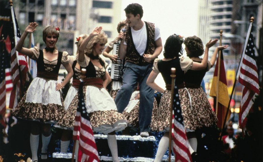 Ferris dances on top of the parade float. 