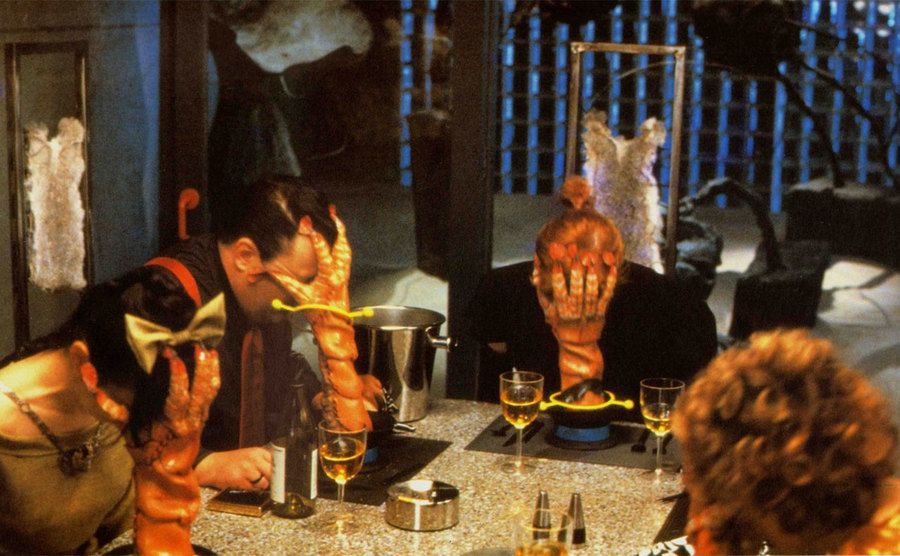 Dinner Guests get attacked by shrimps in a still from the film. 