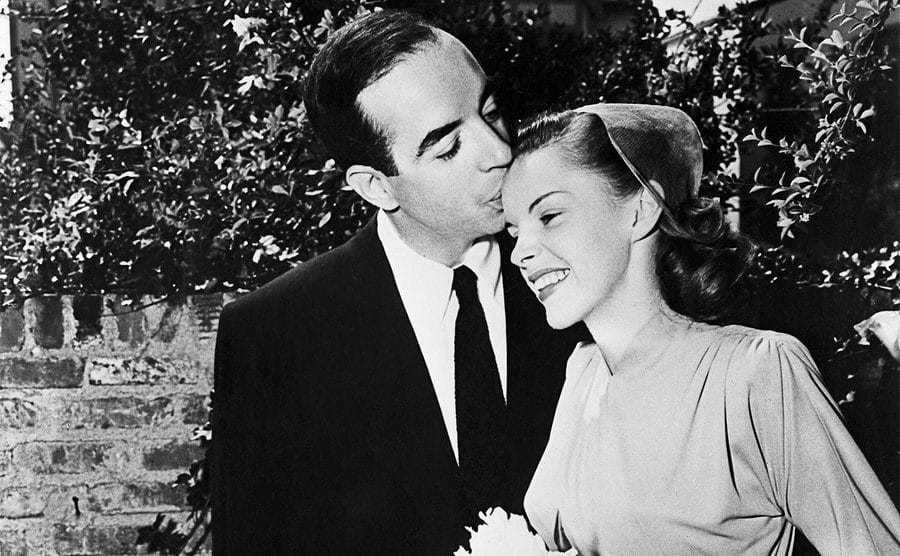 Vincente Minnelli kisses Judy Garland on the brow at their wedding.