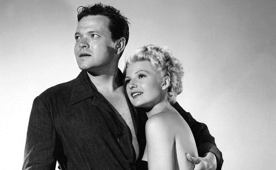 Orson Welles poses with Rita Hayworth on the set of the film 'The Lady from Shanghai'