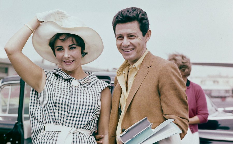 Elizabeth Taylor and Eddie Fisher arrive at an event. 