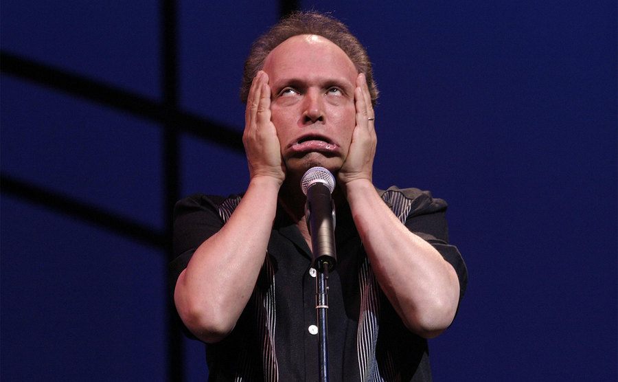 Billy Crystal makes funny faces from the stage. 