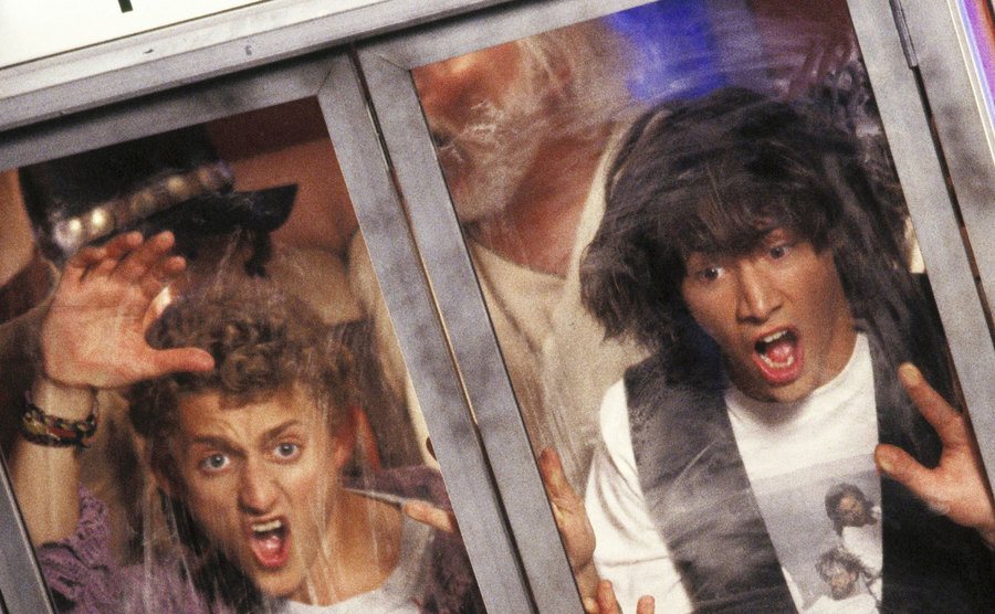 Bill and Ted and looking scared while trapped in the phone booth. 